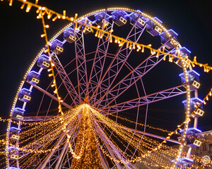 Szeged, Hungary, Giant christmas market at next to Szeged cathedral. Hungarian foods, drinks, presents and gifts. Giant labirintyh and ferris whhel for children