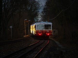 Festively illuminated Cogwheel Railway Line No. 60 in Budapest, Hungary. This is a Christmas-time decoration. Its Hungarian name is Fenyfogaskereku