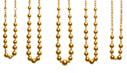 Array of gold-colored necklaces, hanging against a stark black background