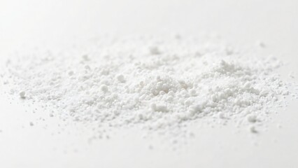 A pile of fine white powder with varying particle sizes on a plain white background