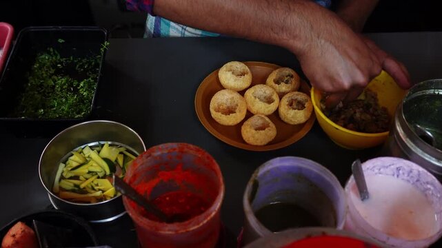 Street Side Vendor Making Pani Puri / Golgappa &ndash; Indian Chaat Snack Preparation