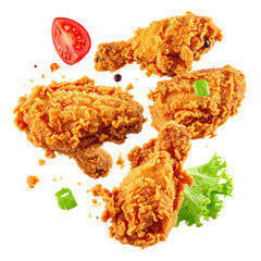 Crispy fried chicken pieces with tomato and lettuce, floating against a black background