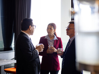 Business professionals in formal discussion during networking event, exchanging ideas and building connections in a corporate setting, showcasing leadership and workplace communication