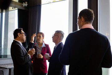 Business professionals engaged in a serious strategic conversation during a networking event. The image reflects leadership, communication, and corporate relationship-building