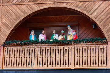 CHOCHOLOW, POLAND - DECEMBER 26, 2025: Traditional nativity scene on wooden street stage.