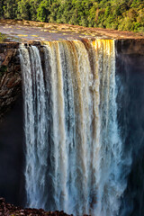 Kaichur waterfall with a beautiful stream of water on a clear sunny day in the middle of the jungle, Guyana. Subtropics, world tourism.
