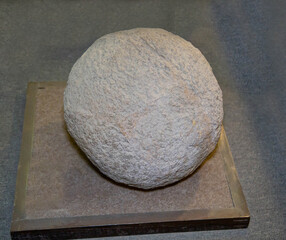 Phosphorite is a gray ball on a dark background. Gems, mineralogy, jewelry.