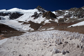 The enchanting beauty of the snowy mountains. The view of snow and rocks on the mountain tops.