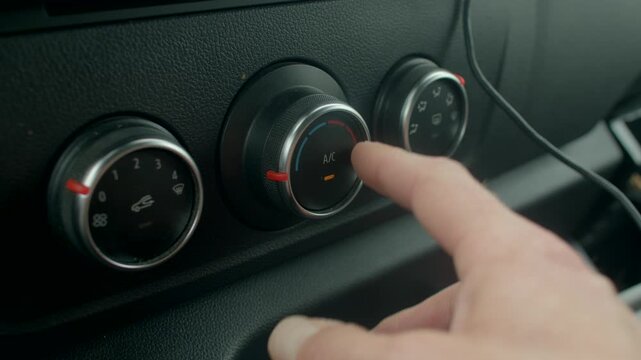 white hand pressing AC button and turning vent dials to increase airflow, warmtocool transition, summer relief during drive, tactile interaction with dashboard controls.