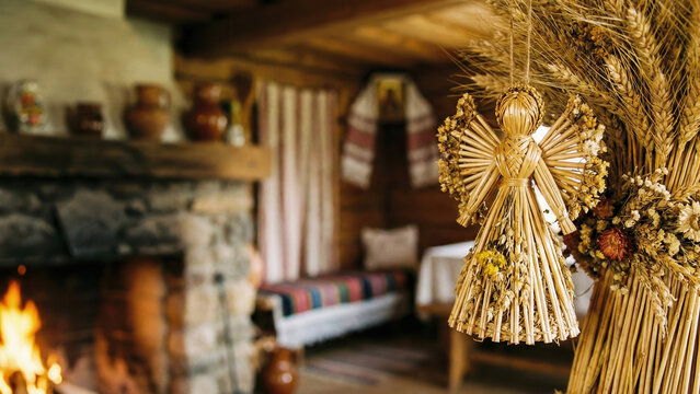 Rustic Christmas straw decoration in cozy wooden house interior