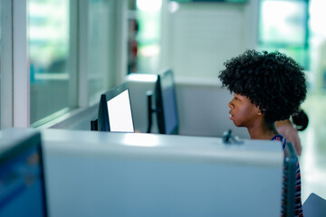 Young learners using library computers for study reflecting education technology self learning routine academic concentration.