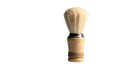 A shaving brush with wooden handle and creamy bristles against a dark backdrop