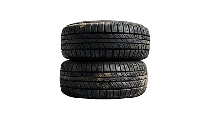 Two black, used tires stacked on top of each other, on a pure black background