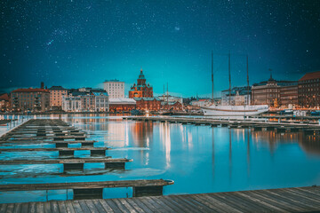 Helsinki, Finland. View Of Evening City And Uspenski Cathedral From Pier. Night stars shining above street