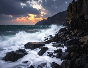 A dramatic seascape shows waves crashing against a rocky shore under a stormy, colorful sky at sunset