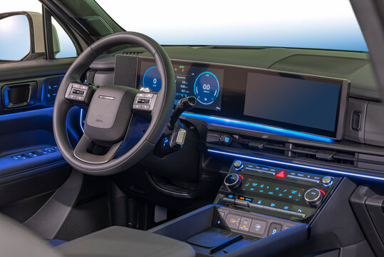 Passenger car dashboard with steering wheel, instrument panel and infotainment display