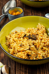 A cozy serving of meat pilaf on rustic wooden table