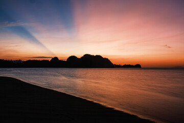 Tropical Beach Sunset Silhouette with Crepuscular Rays