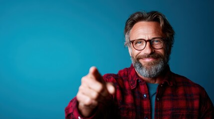 A mature man with a charming smile playfully points at the viewer, showcasing a sense of humor and warmth that embodies wisdom and joy in an engaging, friendly portrait.