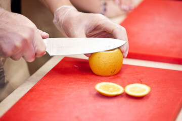 slicing tomato on a chopping board