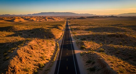 An isolated road cuts through the expansive desert landscape stretching towards distant mountains