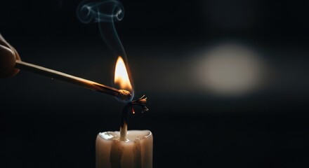 Intimate portrait capturing the lighting of a candle with a match in dark ambience