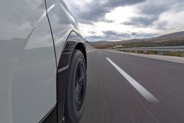 A car driving fast on the open road