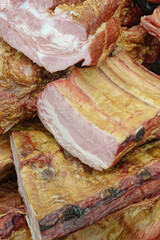 Smoked pork belly or brisket on the counter of a butcher shop