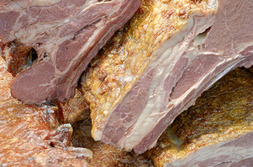 Smoked pork belly or brisket on the counter of a butcher shop