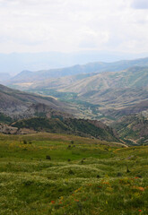 Armenian mountain landscape with winding paths and green valleys