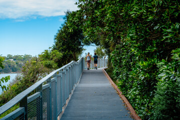 Taken at Hungry Point Reserve on the Cliff Top Walk in December 2025, this photo shows the coastline views toward Bundeena and Maianbar, with people enjoying hiking and coastal life.