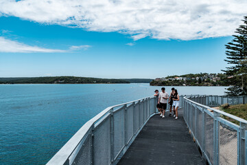 Taken at Hungry Point Reserve on the Cliff Top Walk in December 2025, this photo shows the coastline views toward Bundeena and Maianbar, with people enjoying hiking and coastal life.