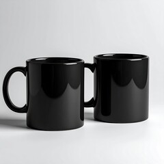 Two glossy black mugs, side-by-side, on a light background