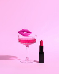 Girls' cocktail party, creative concept with champagne glass and pink lipstick