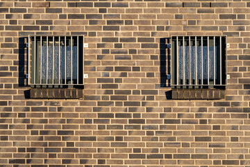 barred and opaque windows in building wall