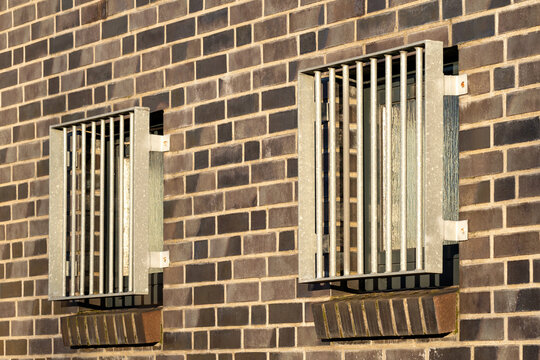 barred and opaque windows in building wall
