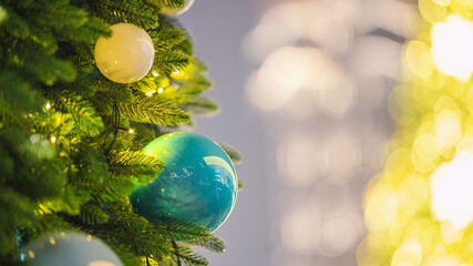 Christmas tree with white and blue ornaments and warm festive lights