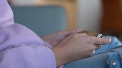 A child holding a game controller while playing a video game. Close-up. After-school entertainment and relaxation. A child playing a video game.