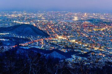 Night view of Sapporo cityscape in winter at twilight from Mt. Moiwa observation, the best city view point, Sapporo, Hokkaido, Japan