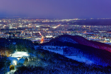 Night view of Sapporo cityscape in winter at twilight from Mt. Moiwa observation, the best city view point, Sapporo, Hokkaido, Japan