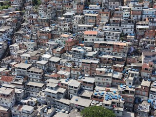 Aerial drone view of Favela Of Cantagalo, Rocinha favelas spread out on the mountain in Sao Conrado , Rio de Janeiro, Brazil.