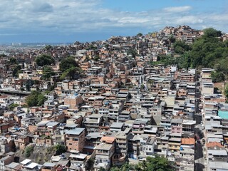 Aerial drone view of Favela Of Cantagalo, Rocinha favelas spread out on the mountain in Sao Conrado , Rio de Janeiro, Brazil.