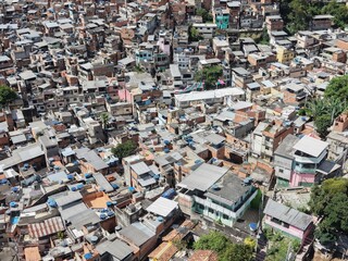 Aerial drone view of Favela Of Cantagalo, Rocinha favelas spread out on the mountain in Sao Conrado , Rio de Janeiro, Brazil.