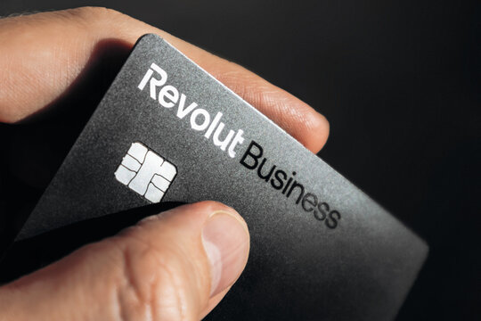 Nice, France - December 9, 2025: Male hand holding Revolut business bank card outdoors