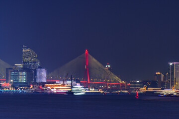 Night view of Yangpu Bridge over the Huangpu River in Shanghai, China.