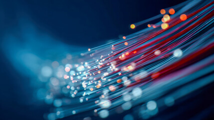 Fiber optic cables glowing with multicolored lights against a dark blue background symbolizing high-speed digital data transmission technology and connectivity advan