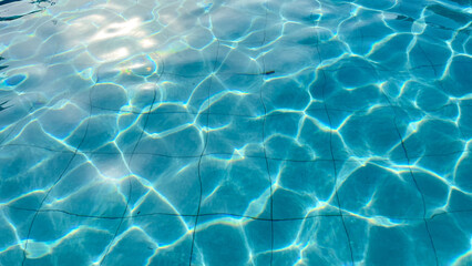 Fototapeta premium Sunlit Water Ripples Texture in Pool