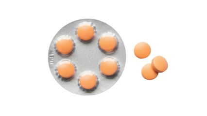 Isolated round orange pills in blister pack, medication against various diseases and symptoms