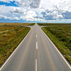 Fototapeta premium Two roads diverge in a vast, open landscape under a partly cloudy sky