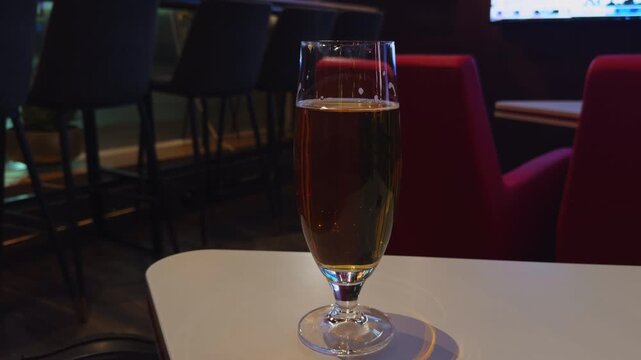 Relaxed sports bar scene with beer and seating, Dimly lit sports bar featuring beer and lounge chairs